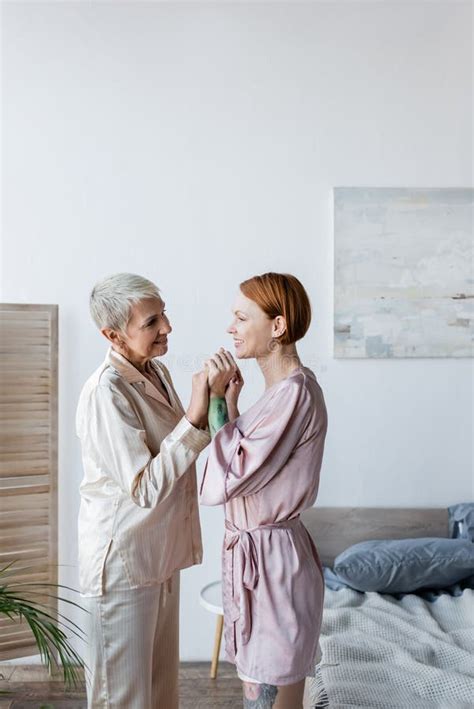 Smiling Lesbian Couple Holding Hands In Stock Image Image Of Bedroom