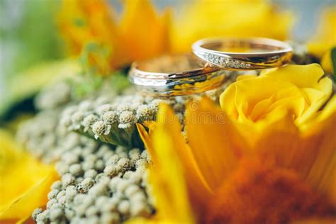 Gold Wedding Rings On The Yellow Bride Bouquetdeclaration Of Lo Stock