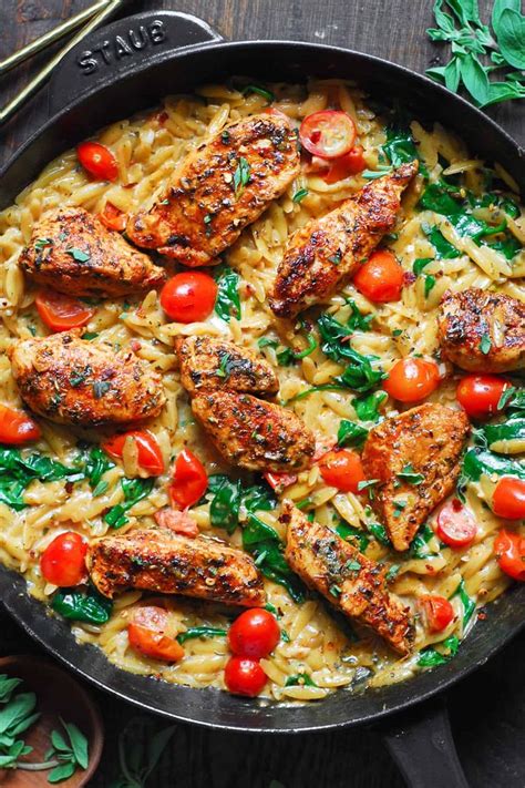 Creamy Chicken Orzo With Tomatoes And Spinach In A Cast Iron Skillet