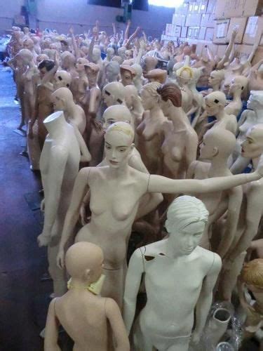 A Group Of Naked Mannequins Standing Next To Each Other In A Room