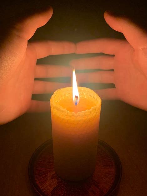 Premium Photo Close Up Of Hand Holding Lit Candle