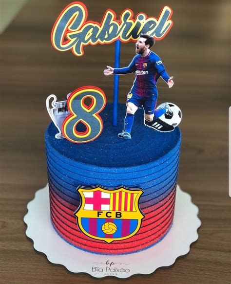 A Birthday Cake With A Figurine Of Barcelona S Soccer Player And The