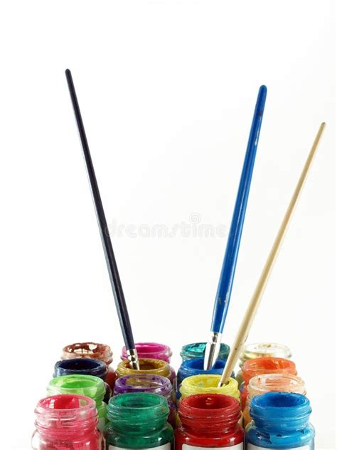 Group Of Colorful Of Open Glasses Bottles Of Poster Color With Three Paintbrushes Dipped In