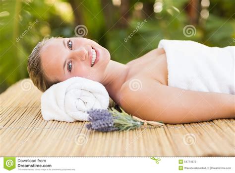 Peaceful Blonde Lying On Bamboo Mat With Flowers Stock Photo Image Of