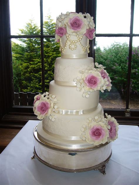 Ivory Four Tier Wedding Cake With Moulded Lace Sugar Pearls And Dusky