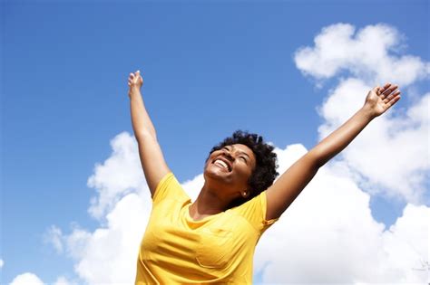 Premium Photo Cheerful Young Woman With Hands Raised Towards Sky