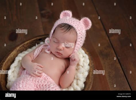 An Overhead Shot Of A Two Week Old Newborn Baby Girl Sleeping In A