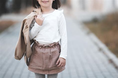 Premium Photo | Midsection of girl standing at street 