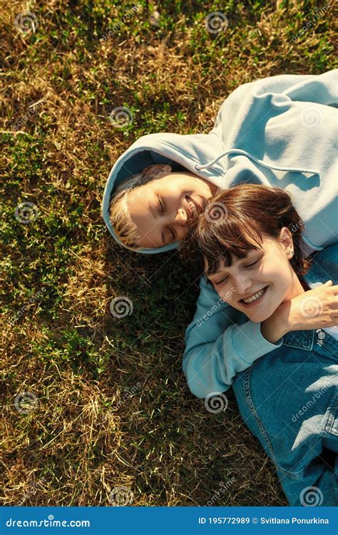 Top View Of Happy Lesbian Couple Of Girls Lying On The Grass In Summer Park Women In Love