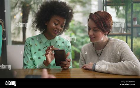 Happy Friends Laughing And Smiling Two Young Diverse Women At Coffee