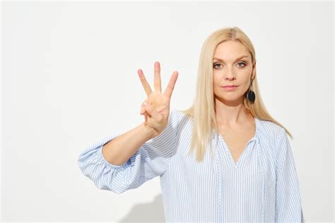 Premium Photo Attractive Blonde Woman Shows Three Fingers Counting With Fingers