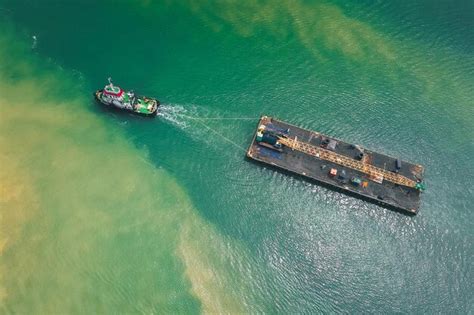 Premium Photo Aerial View Of Tugboat Hauling Ship In Sea