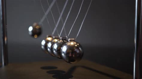 Closeup Video Of Metal Newton Cradle Swining On Gray Background Stock