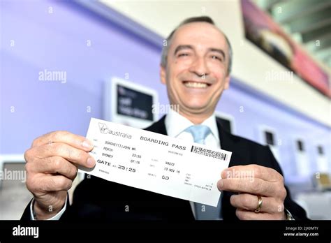 Virgin Australia CEO John Borghetti holds up a boarding pass during a