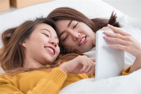 Asia Lesbian Lgbt Couple Lay On Bed And Hug Rainbow Color Pillow Heart Shape With Happiness