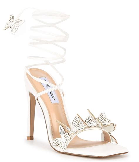 A White High Heeled Shoe With Butterfly Decorations On The Toes And