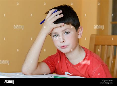 Boy Doing School Homework Is Tired And Bored Stock Photo Alamy
