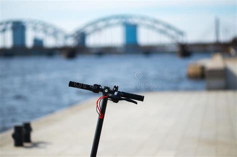 Scooter Handle With Red Switches And Small Golden Screws Stock Photo