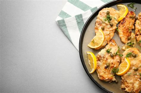 Premium Photo Plate With Tasty Italian Chicken Piccata On Table