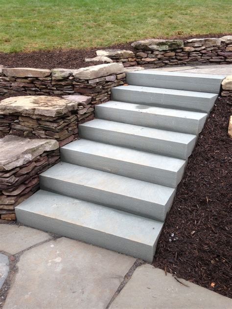 Backyard Patio And Natural Stone Retaining Walls With Stairs