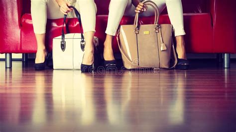 Two Women Sitting On Sofa Presenting Bags Stock Image Image Of