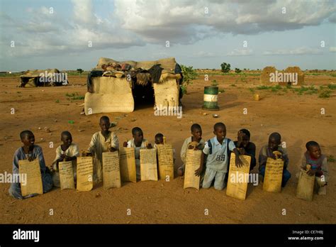 Sudanese Refugee Children In An Open Air School With Wood Notebooks