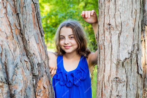 Premium Photo Girl Long Curly Hair Lean On Tree Trunk Summer Camp