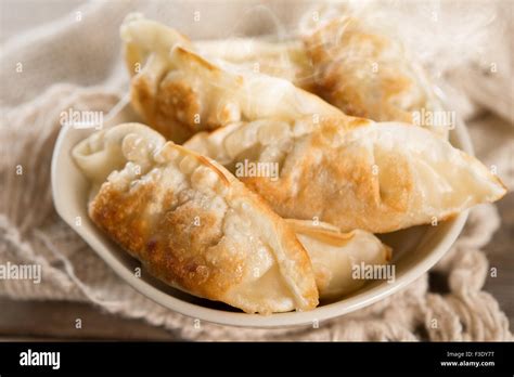 Close Up Fresh Pan Fried Dumplings On Bowl With Hot Steams Asian