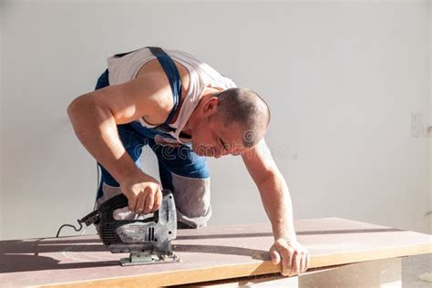 Closeup Hand Of Carpenter Woodworker With Professional Cutting Tool