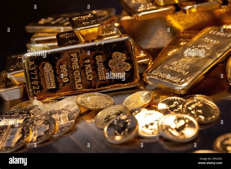 Munich, Germany. 16th Mar, 2023. Gold bars and gold coins of different sizes lie in a safe on a ...