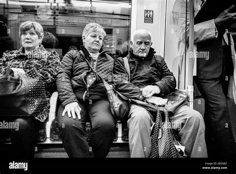 Three Mature Caucasian Adults Sitting In An Underground Tube Train Stock Photo Alamy