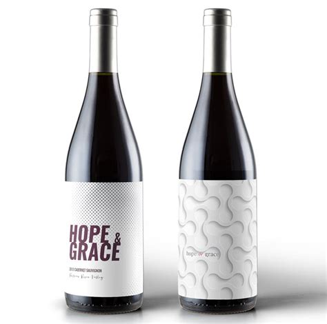 Two Bottles Of Wine Sitting Next To Each Other On A White Surface With