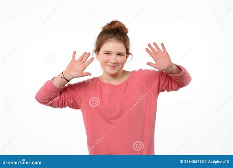 Studio Portrait Of Cheerful Young Girl Making Funny Face White