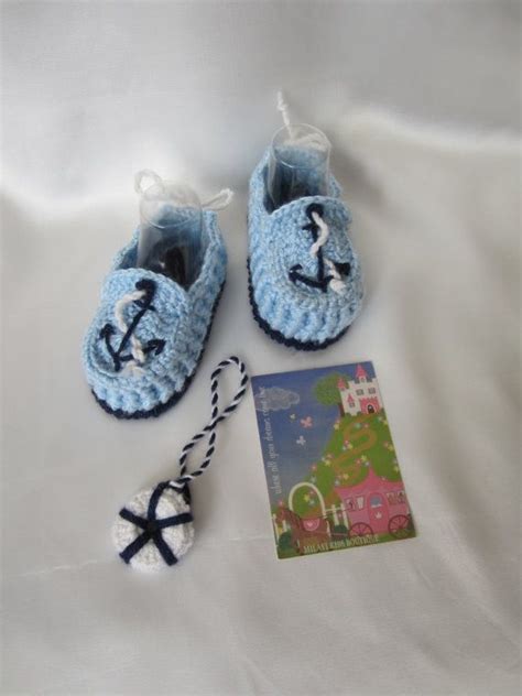 There Is A Pair Of Baby Shoes And A Book On The Bed