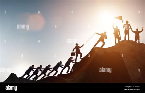 Concept of teamwork with team climbing mountain Stock Photo - Alamy