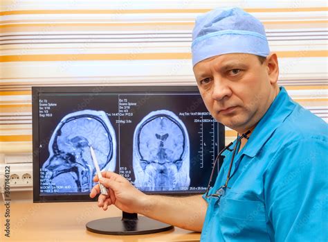 Mature Doctor Examines a MRI Scan of the Brain Stock Photo | Adobe Stock