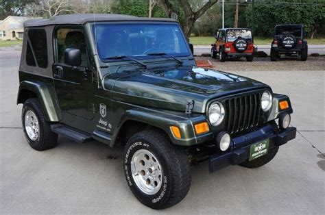 A Green Jeep Parked In A Parking Lot