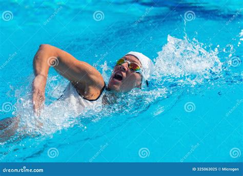 Female Swimmer In White Swim Cap And Goggles Performing Freestyle