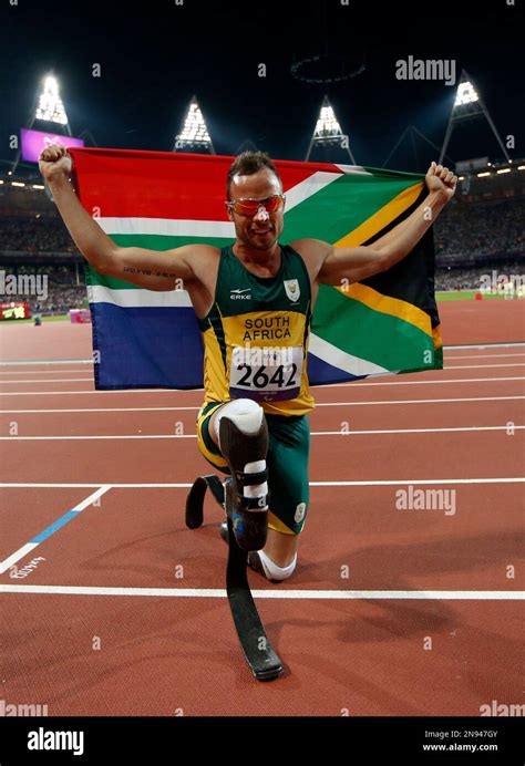 Gold Medalist South Africa S Oscar Pistorius Poses With A Flag As He