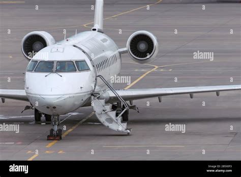 Small Passenger Airplane Parked At The Airport With An Open Door And