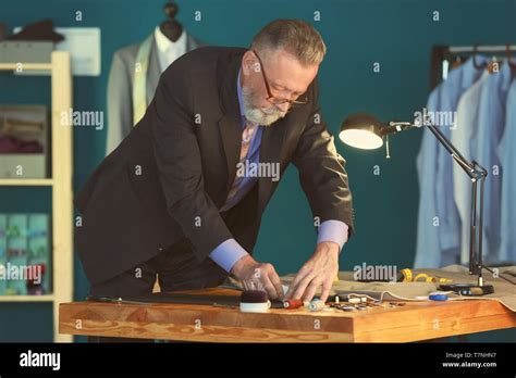 Mature Tailor Marking Fabric With Chalk In Atelier Stock Photo Alamy