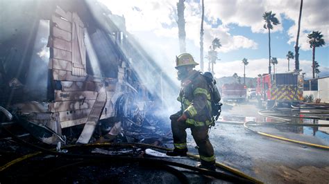 firefighters battle wind driven fire  palm desert