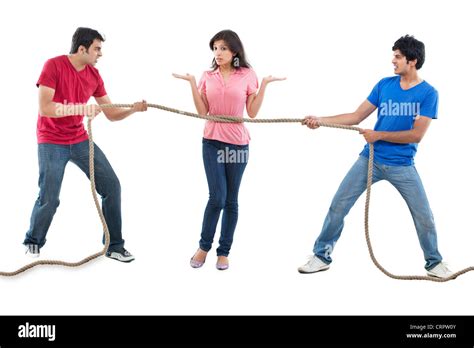 Men Competing For Woman In Tug Of War Stock Photo Alamy