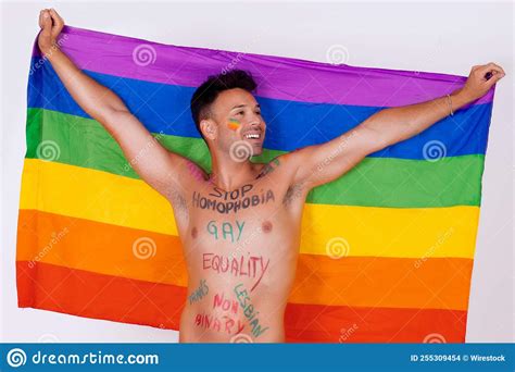 Naked Gay Man Holding The Pride Flag With Painted Words On His Body Claiming His Rights Stock