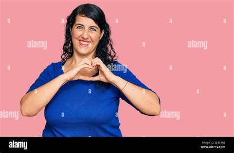 Plus Size Brunette Woman Wearing Casual Clothes Smiling In Love Showing Heart Symbol And Shape