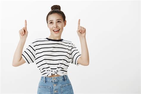 Free Photo Cheerful Attractive Brunette Smiling Broadly Pointing Fingers Up