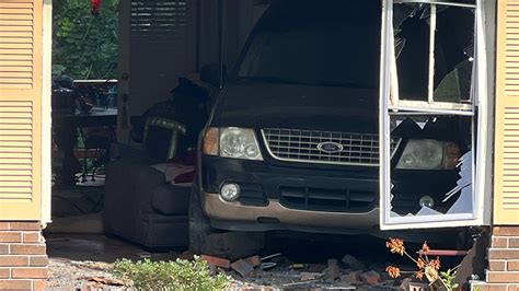 Person Flown To Hospital After Being Trapped Under Car Inside House