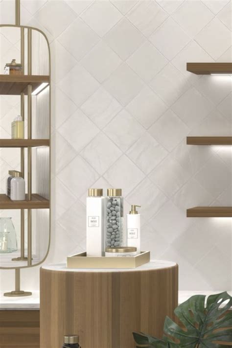 A White Tiled Bathroom With Wooden Shelves And Shelving