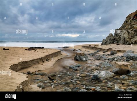 Stream flows into the ocean Stock Photo - Alamy