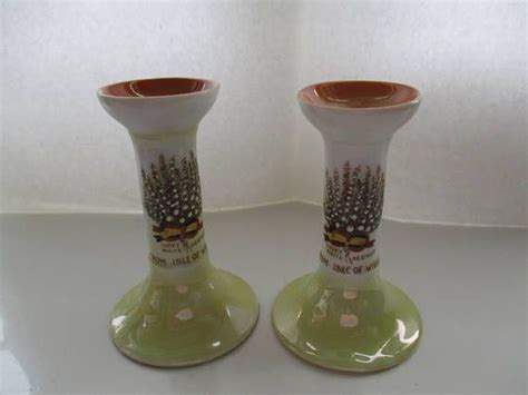 Two Green Vases Sitting Side By Side On A White Counter Top One Has A